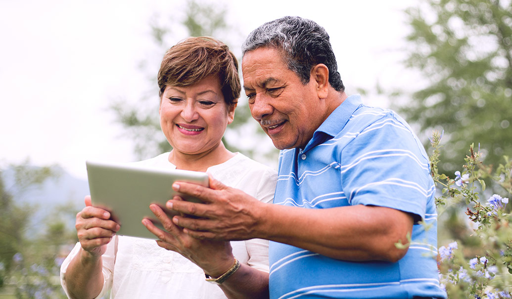Elderly couple looking at tablet